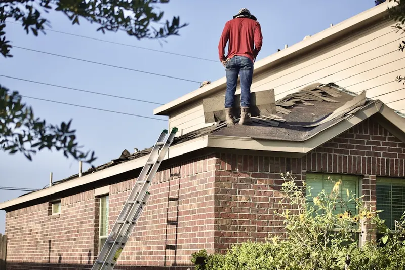 Professional roofer working on a residential roof in Huntwick Forest